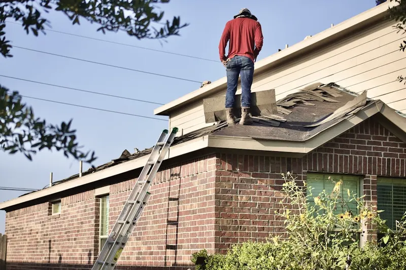 Professional roofer working on a residential roof in Ramtown